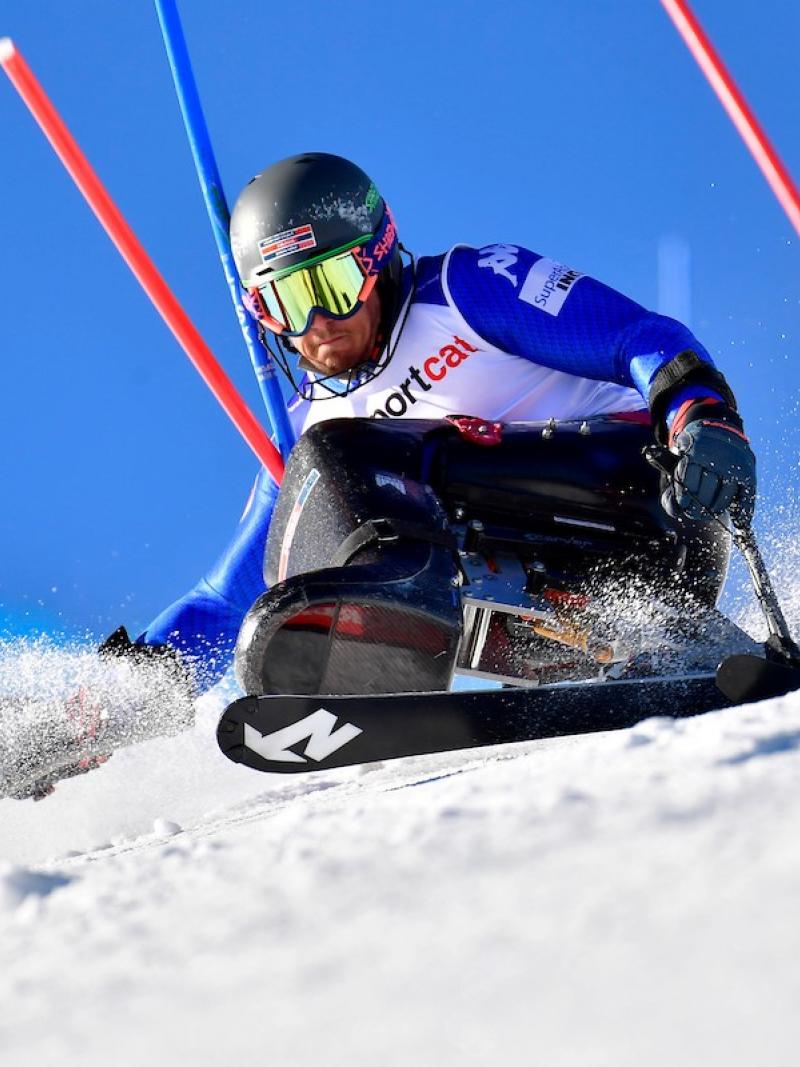 A male sit-skier in a slalom competition