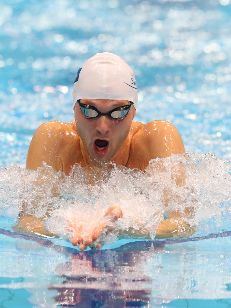 A man swimming breaststroke in a swimming pool
