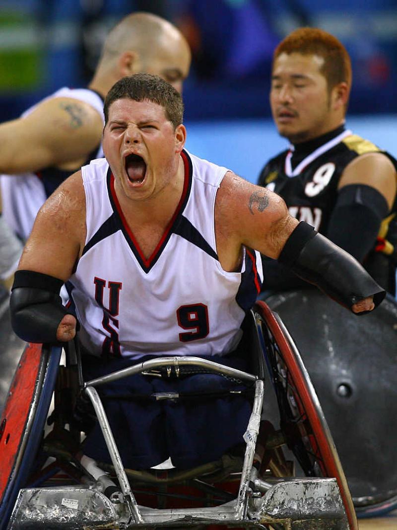Male wheelchair rugby player celebrating 