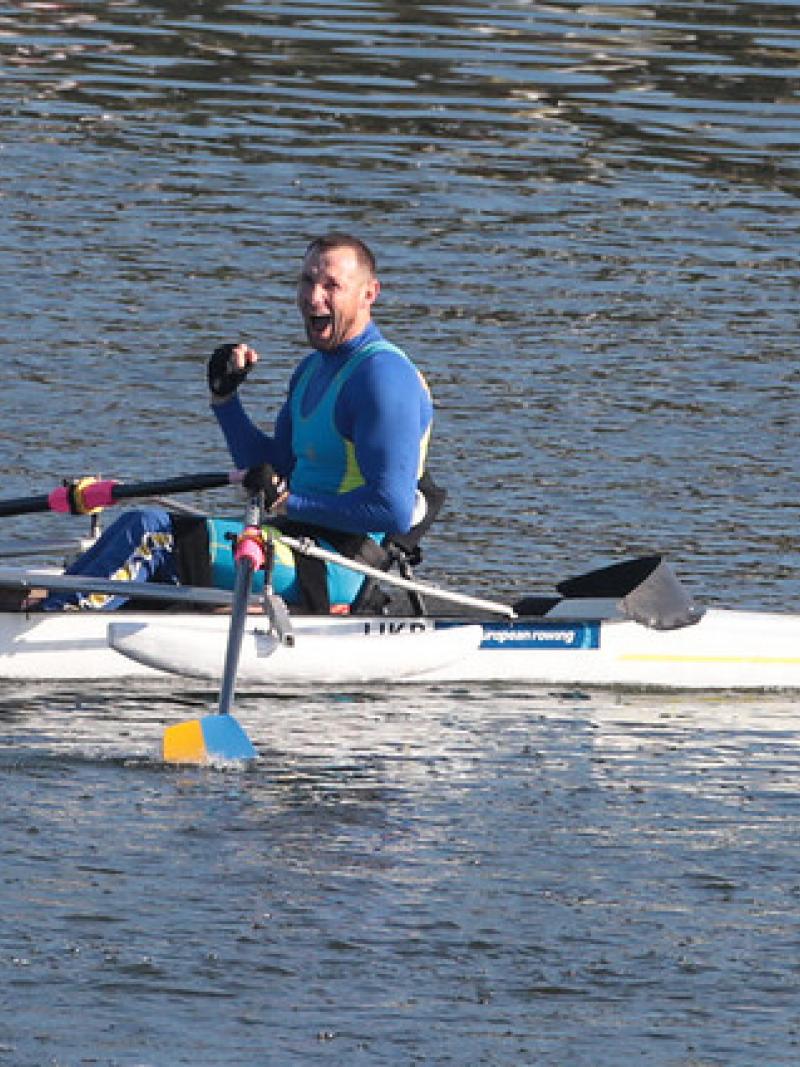 Man celebrates in rowing boat