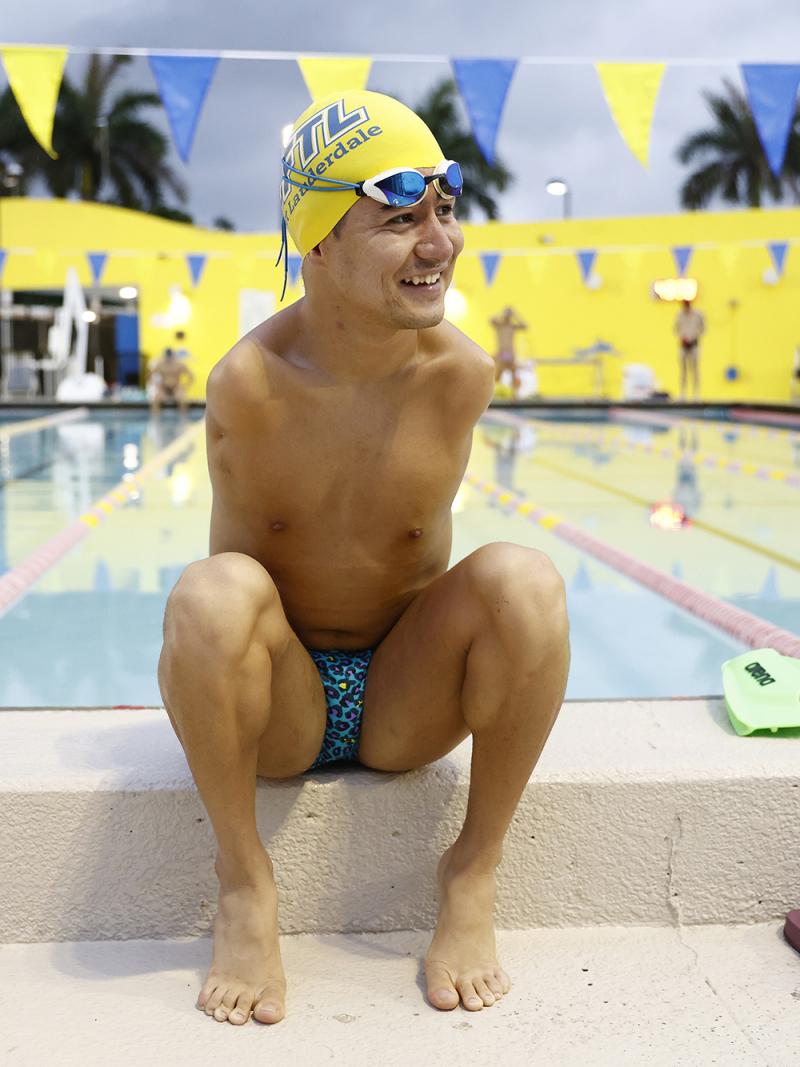 Mohammad Abbas Karimi smiling while sitting next to a swimming pool