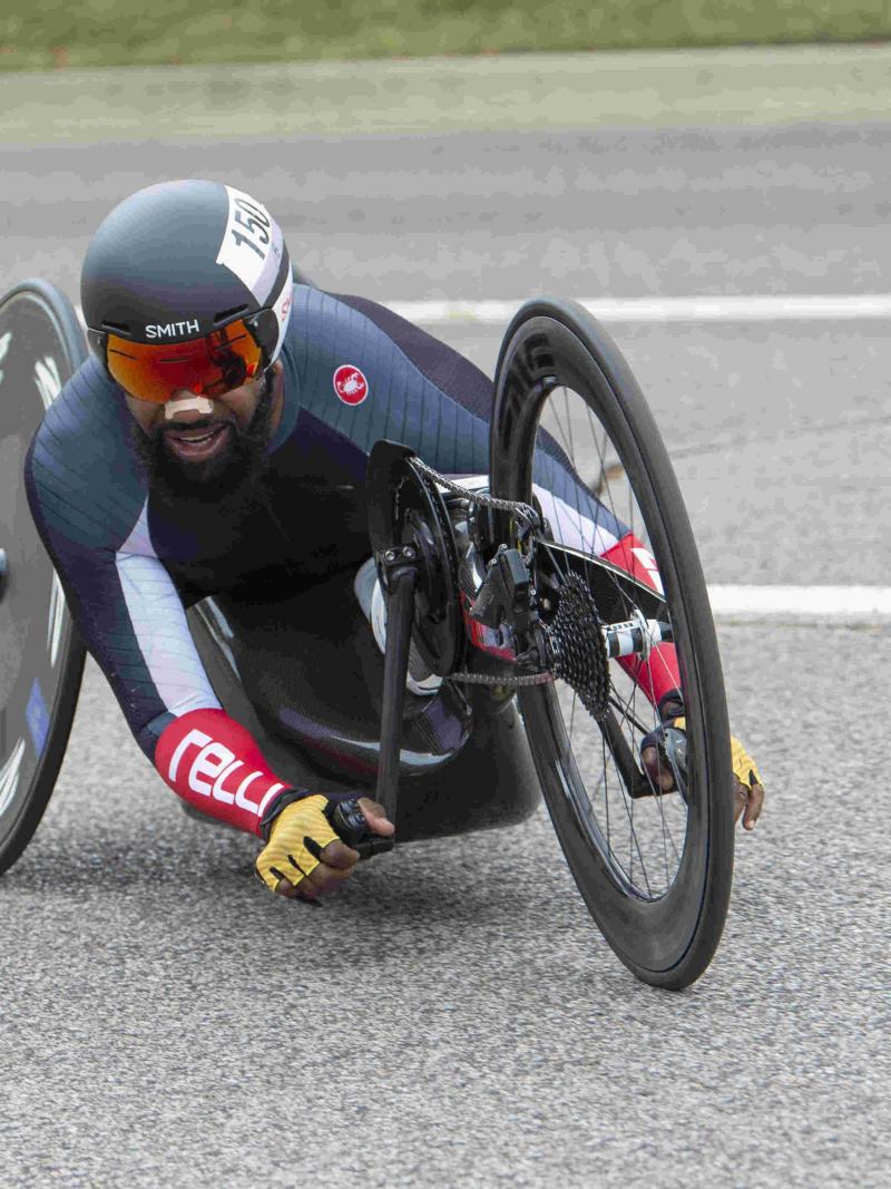Male handcyclist rounds a corner