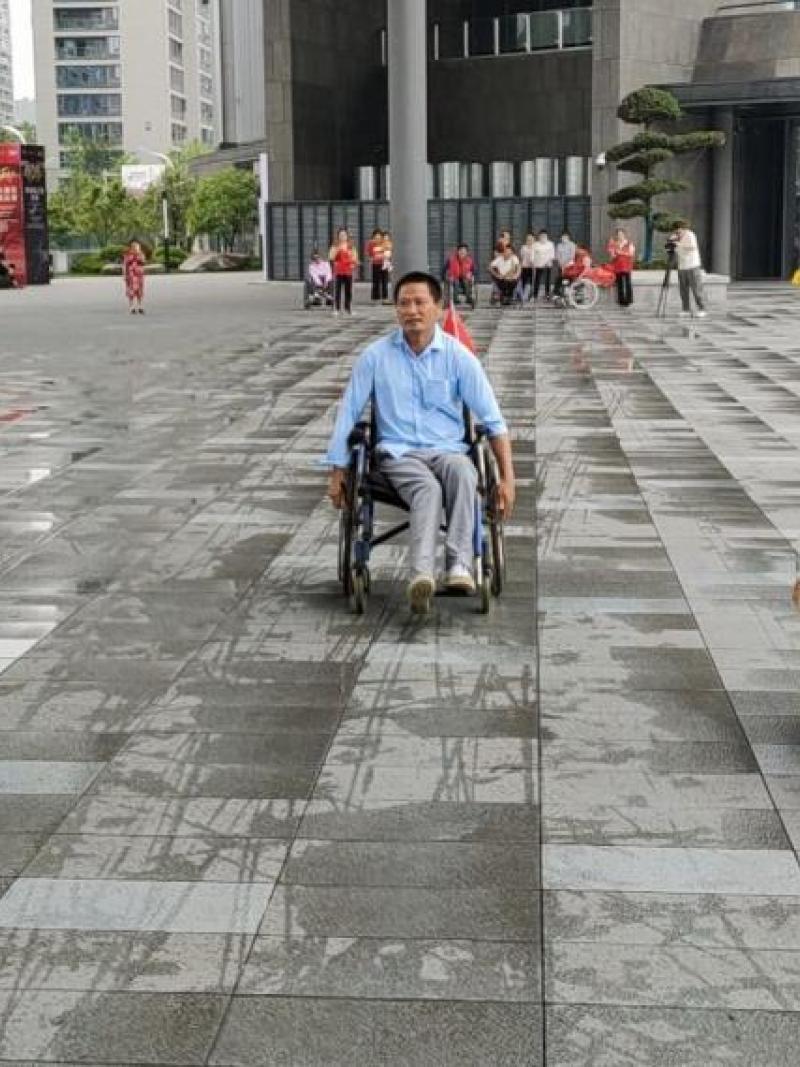 Three men in wheelchairs moving forward