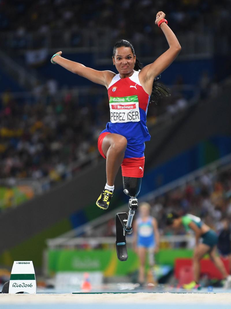 Cuban athlete with a prosthesis in the air after jumping while competing in the long jump