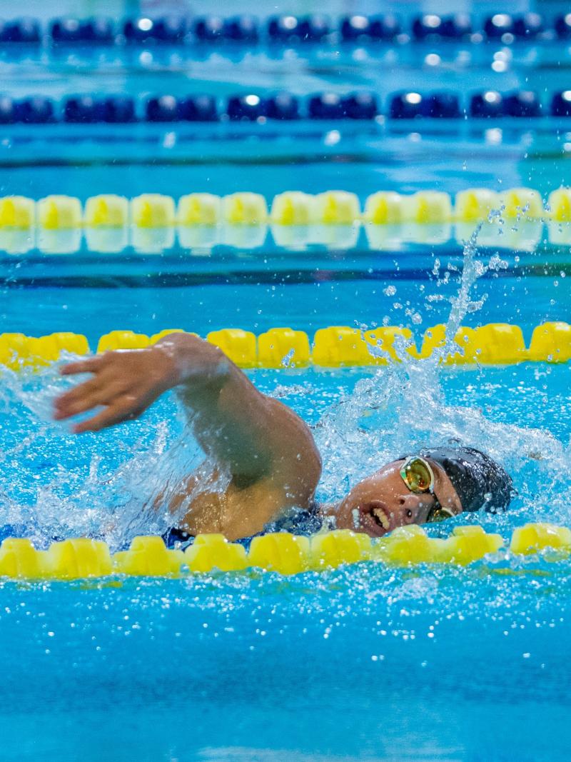A woman swimming in a Para swimming competition