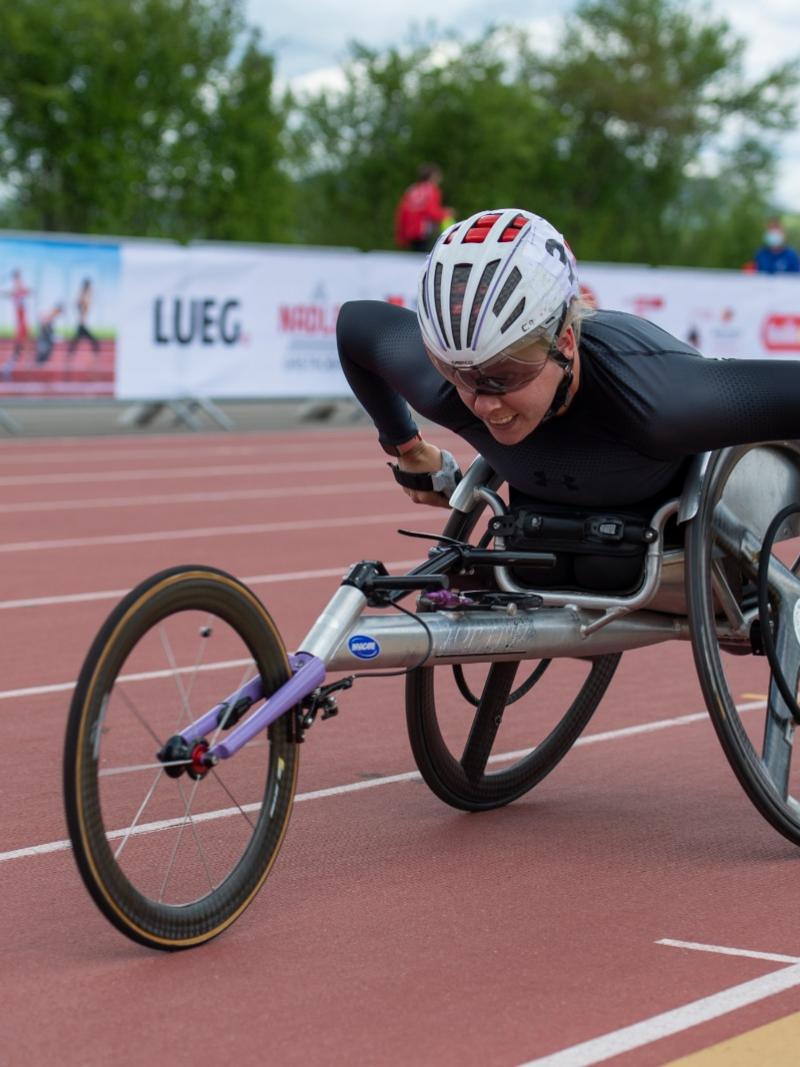 A woman in a racing wheelchair during a Para athletics race