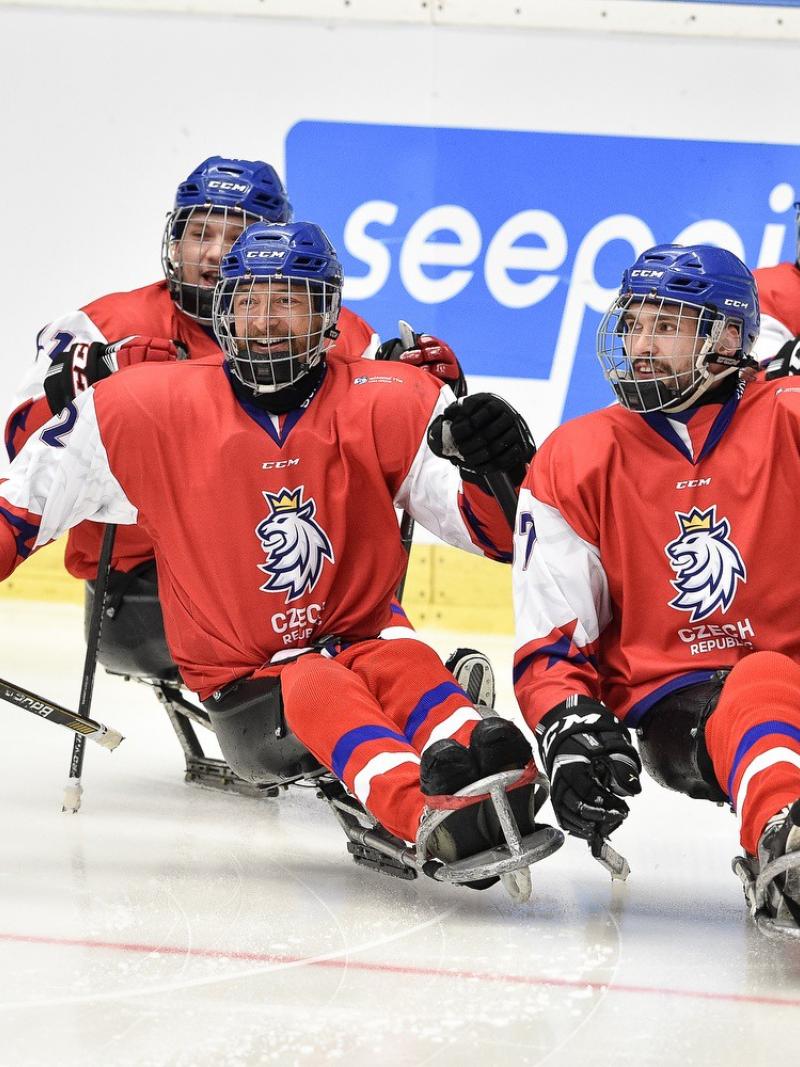 Four Czech Republic Para ice hockey players on an ice rink