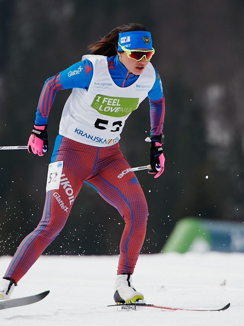 A female cross-country skier in competition