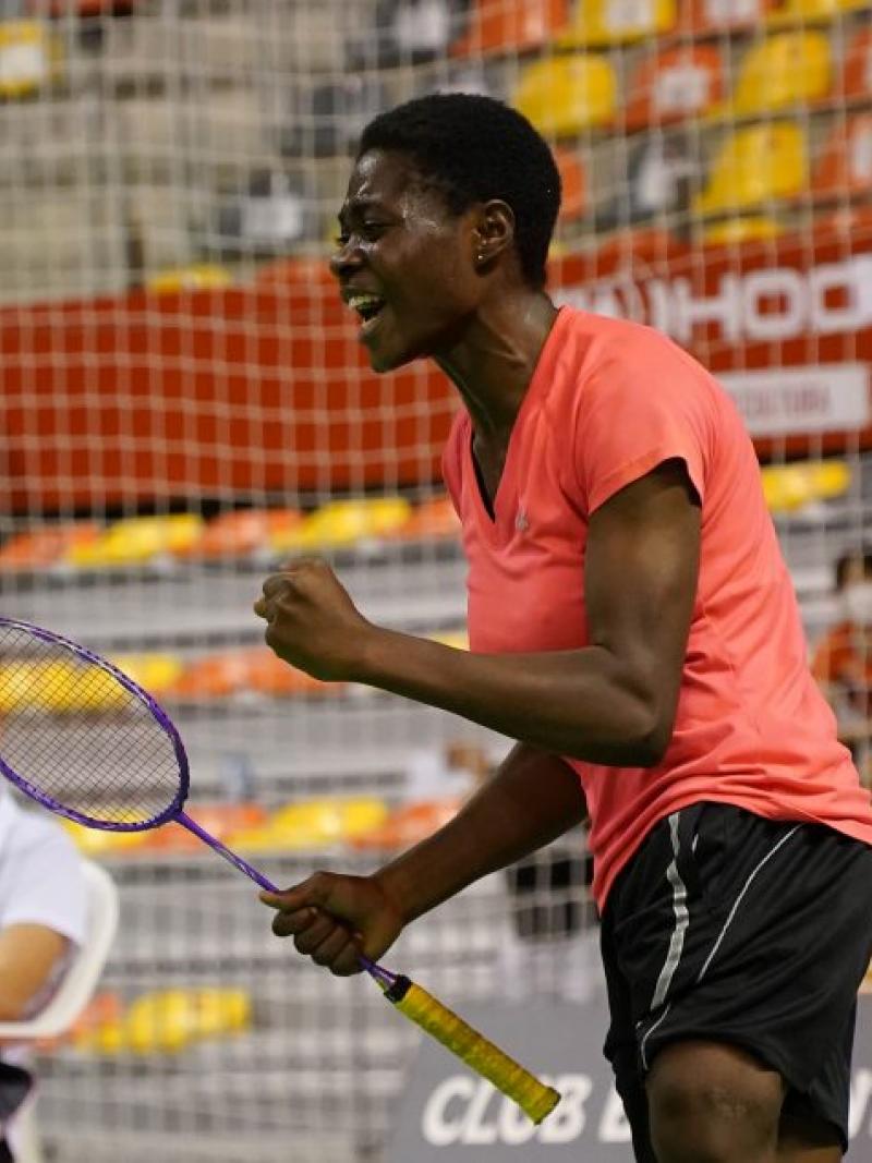 Nigerian Para badminton player Mariam Eniolo Bolaji celebrates with a clinched fist and a scream while holding her racket