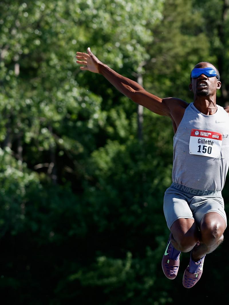 A man blindfolded jumping