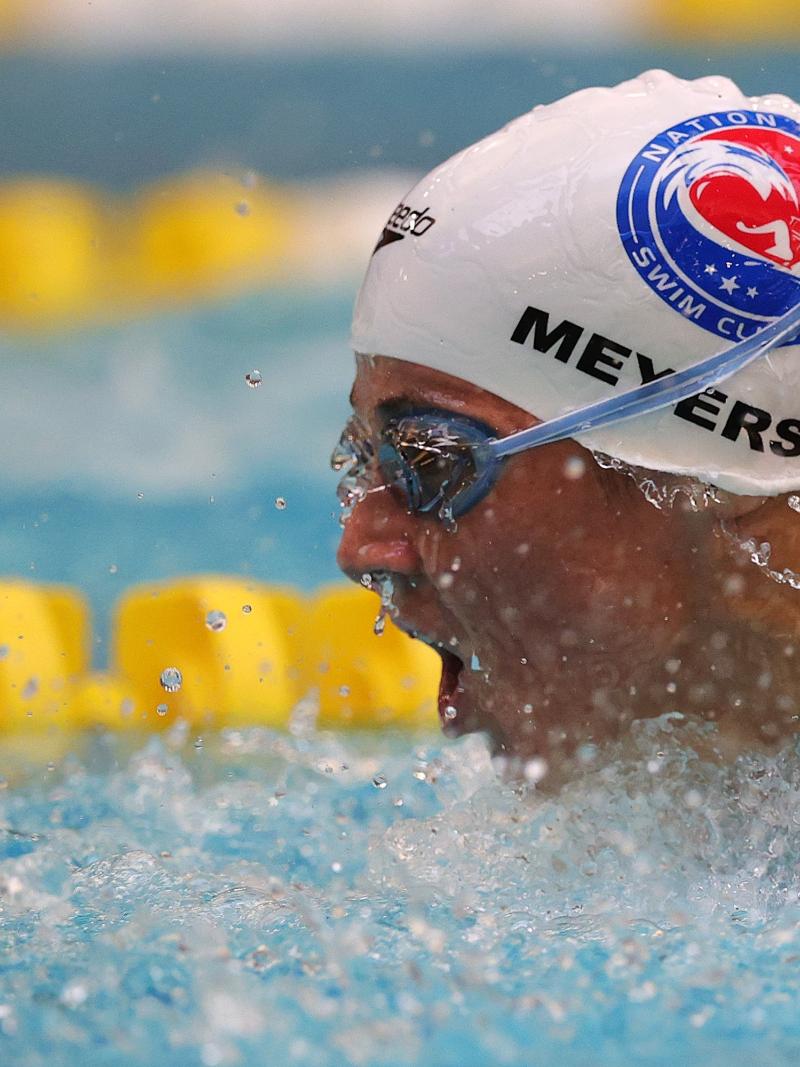 A woman putting her head out of the water during a swimming competition