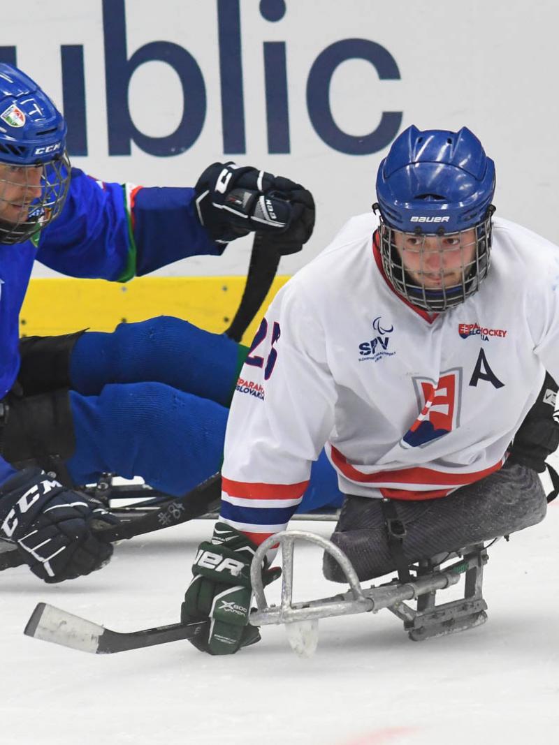 A Slovakian Para ice hockey player followed closely by an Italian player