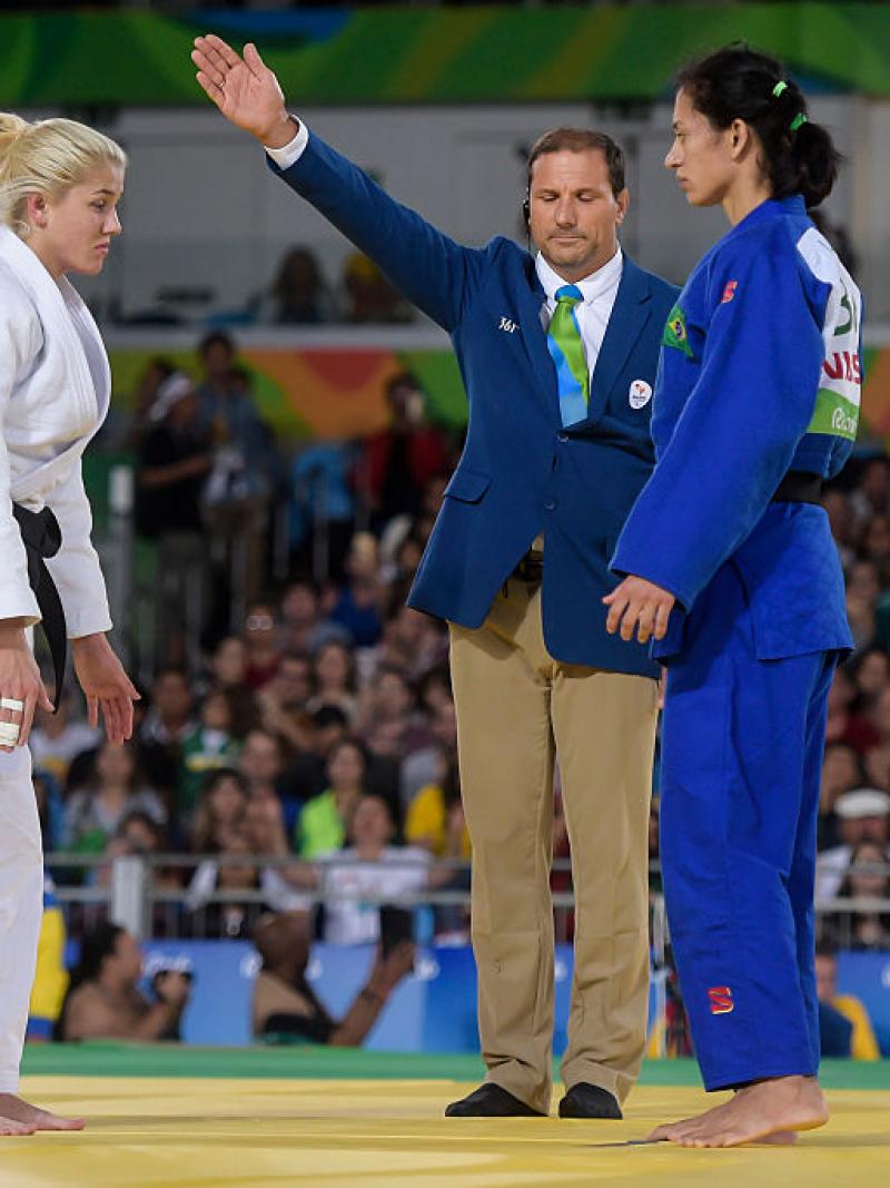 Two female judoka face each other before competing