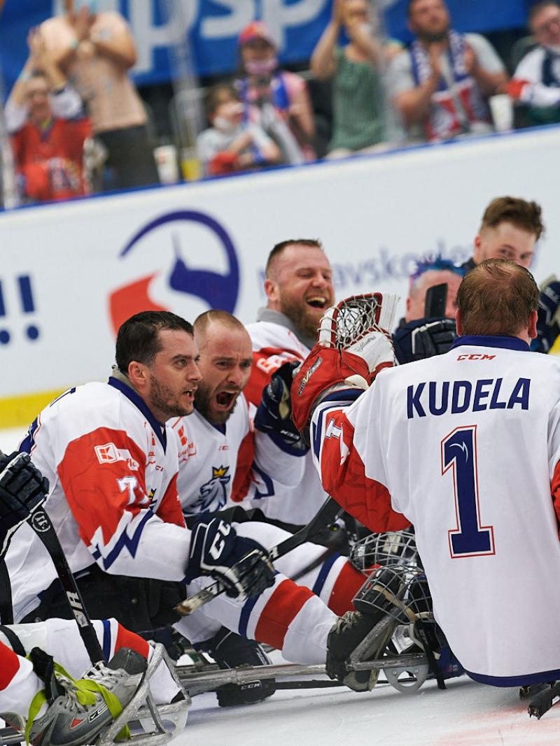 A group of Para ice hockey players celebrating on ice