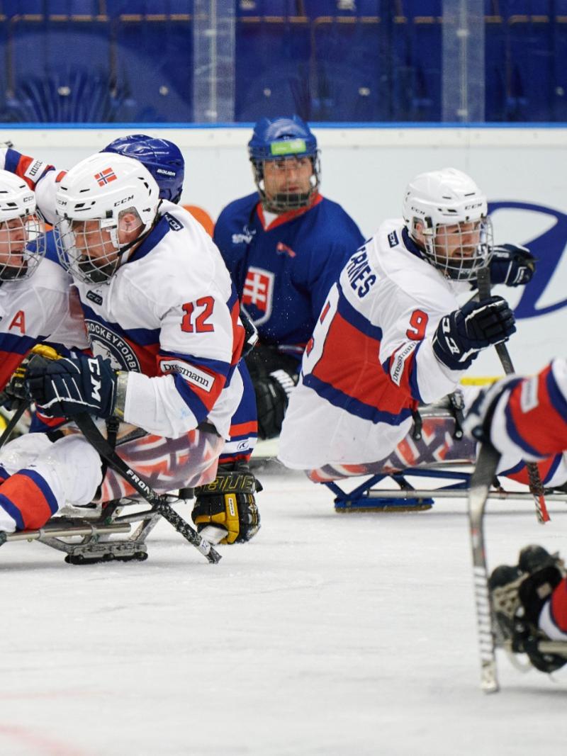 A group of Norwegian Para ice hockey players celebrating on ice