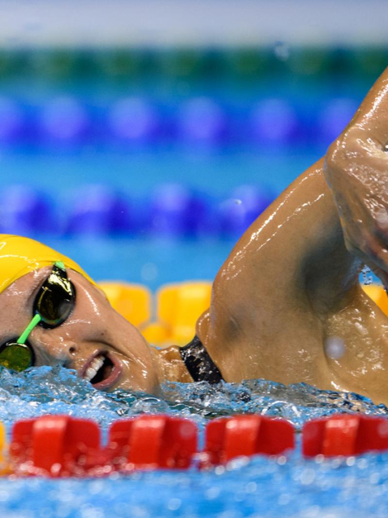 A woman swimming in a pool during a competition