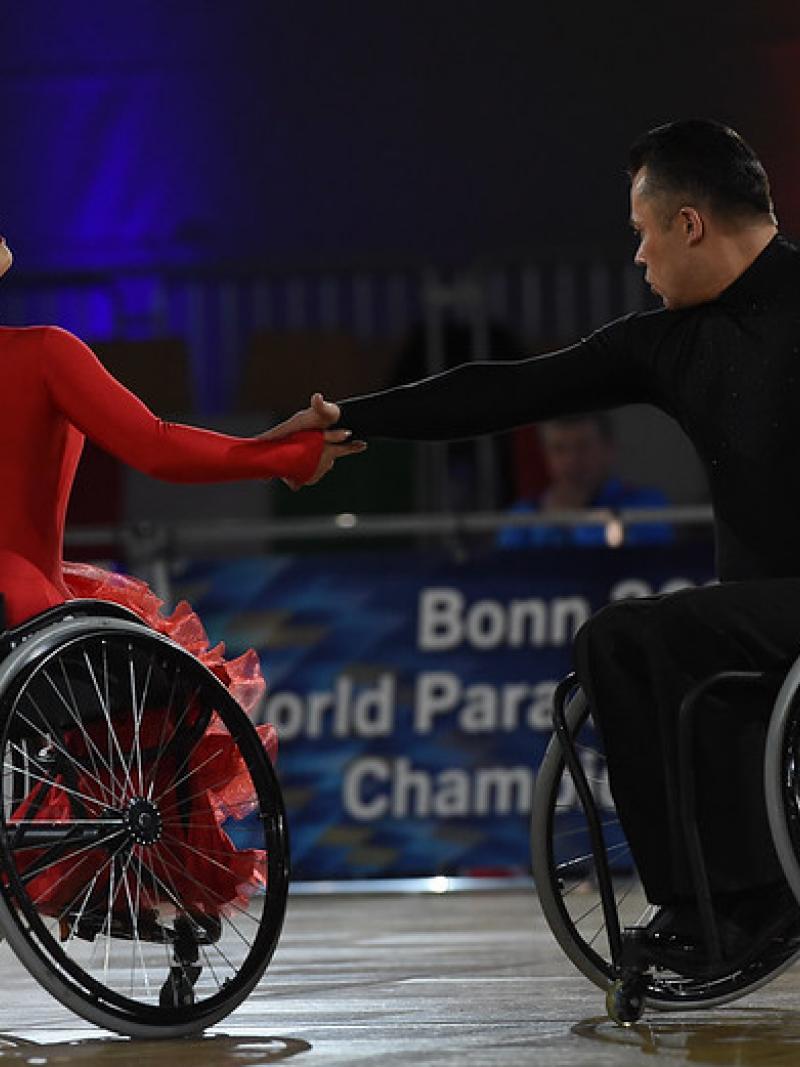 A couple in wheelchairs dancing on a Para dance sport competition