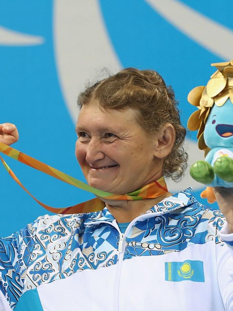 Zulfiya Gabidullina of Kazakhstan celebrates on the podium after winning gold in the Women's 100m Freestyle at the Rio 2016 Paralympic Games.