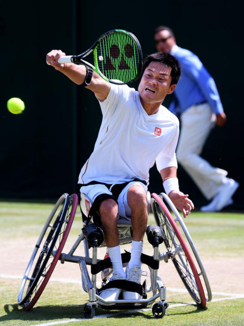 Japanese male wheelchair tennis player does backhand return