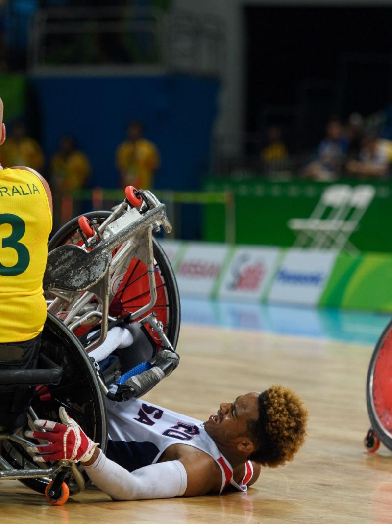 Australia captain Ryley Batt shouts to a team-mate as Josh Brewer is tipped on to the floor