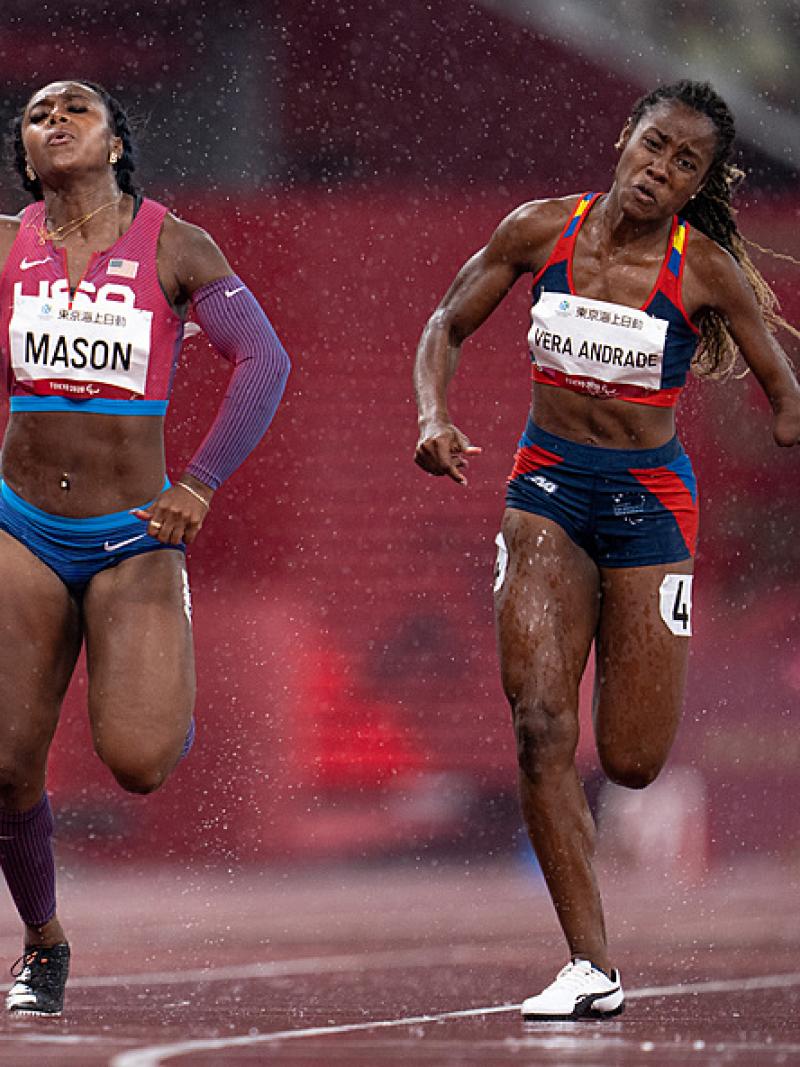 Two female runners in a track under rain