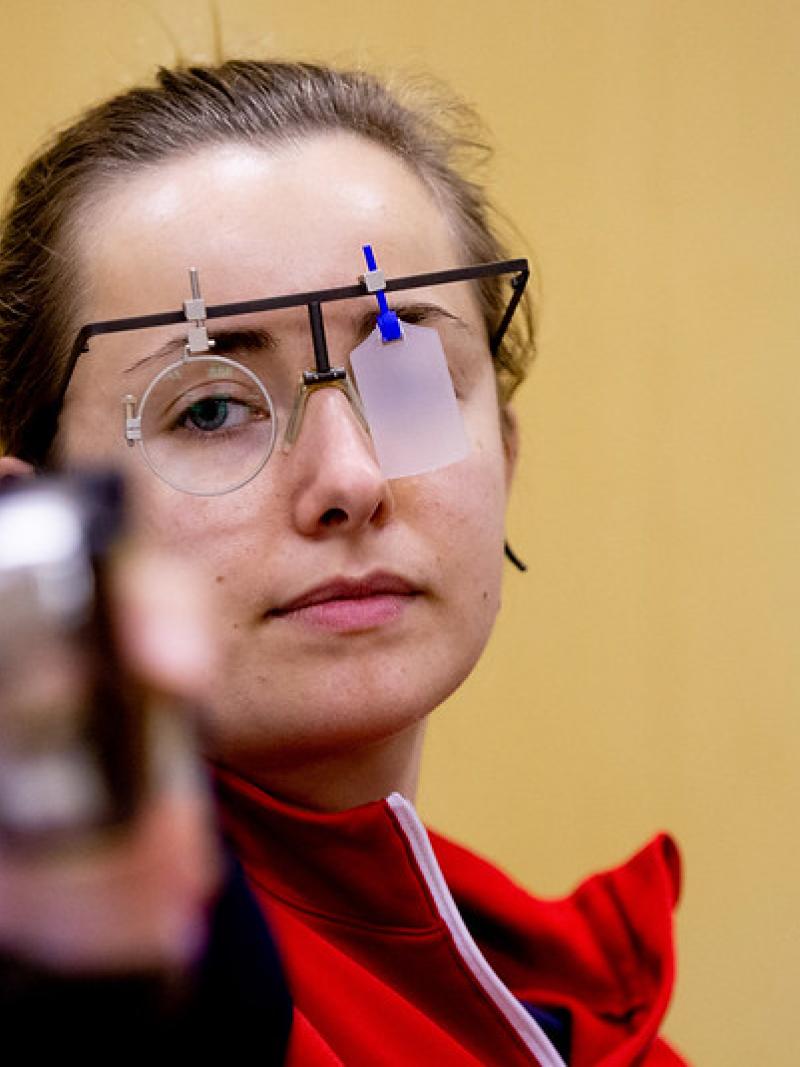 A woman with a pistol in a shooting range