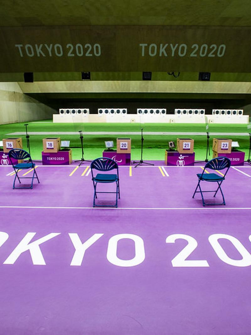 An empty indoor shooting range with Tokyo 2020 written on the floor