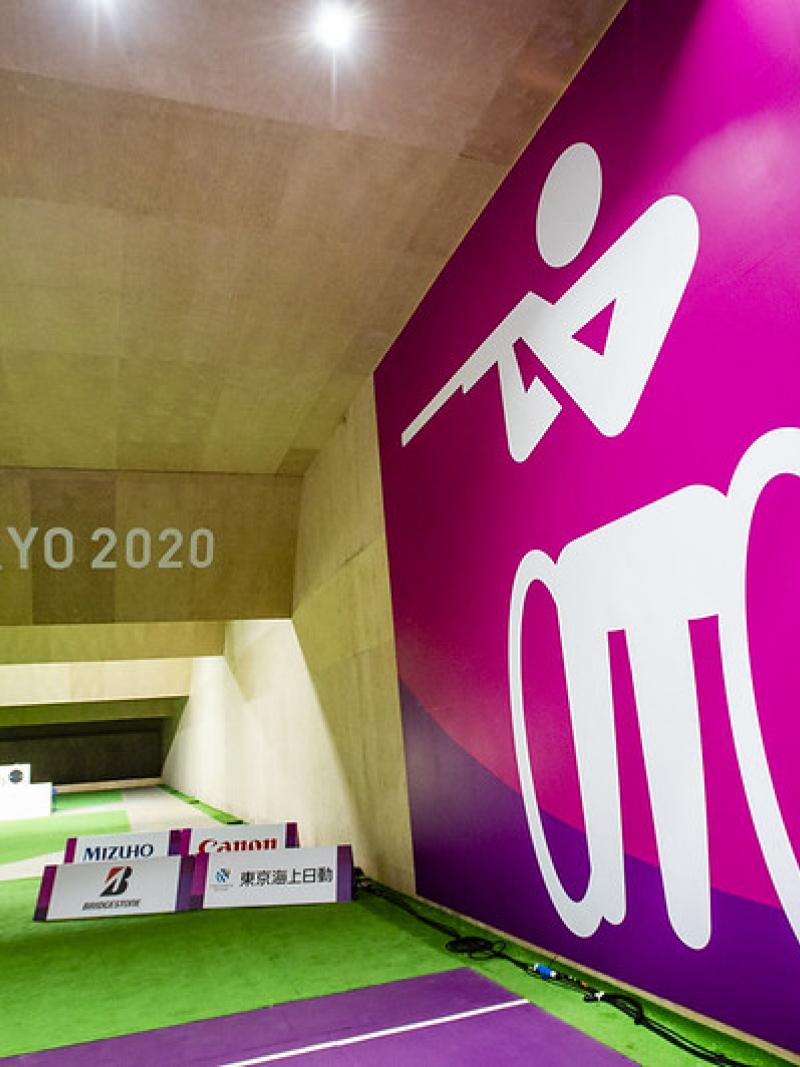A shooting range with a wall showing the shooting Para sport pictogram at Tokyo 2020