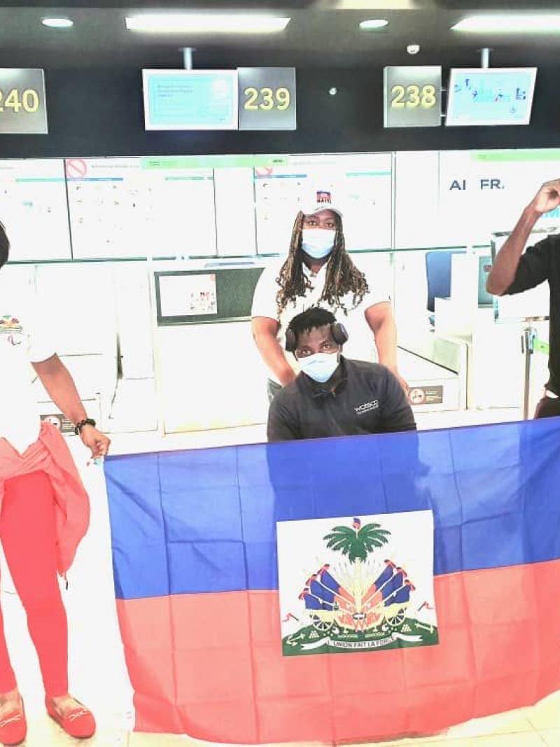Team standing holding the Haiti flag
