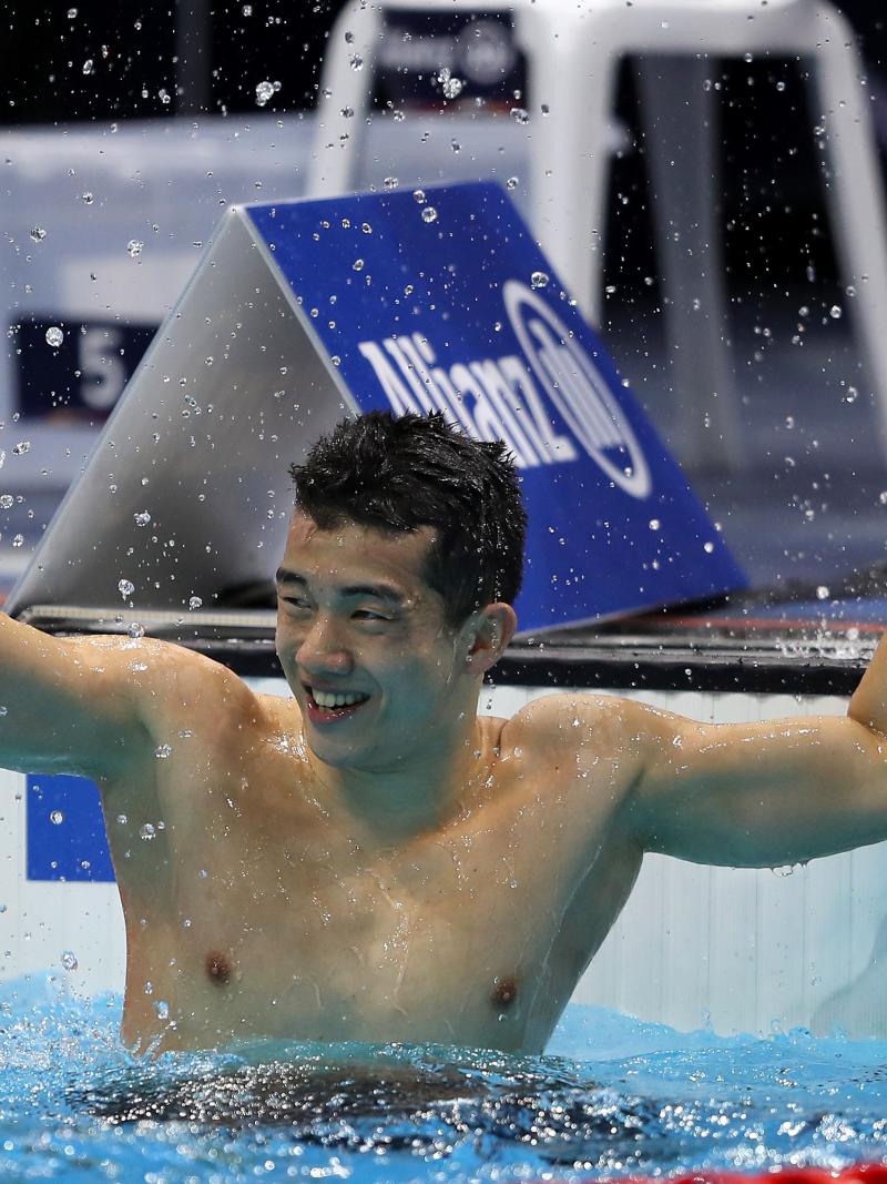 A man celebrating in a swimming pool