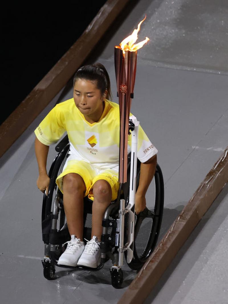 Yui Kamiji goes down ramp holding Paralympic flame at Opening Ceremony