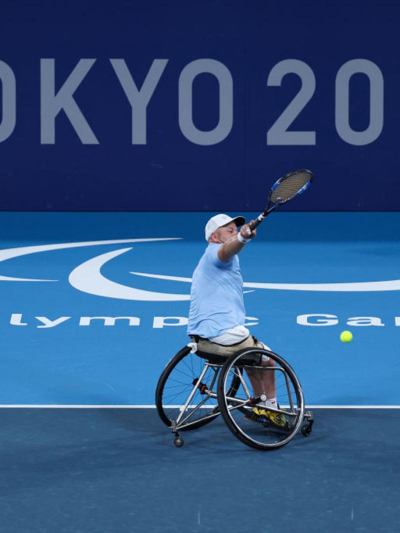 Steven Olsson plays a shot in front of Tokyo 2020 logo