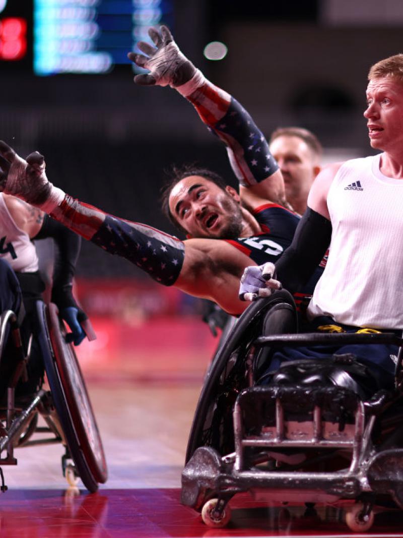 Charles Aoki reaches for the ball past Jim Roberts in the wheelchair rugby gold medal game