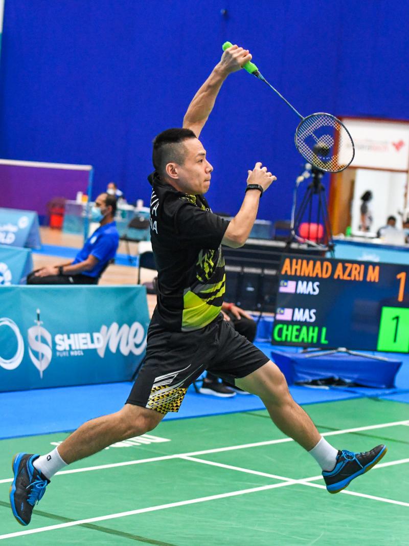 Malaysia's Cheah Liek Hou jumps in the air playing badminton