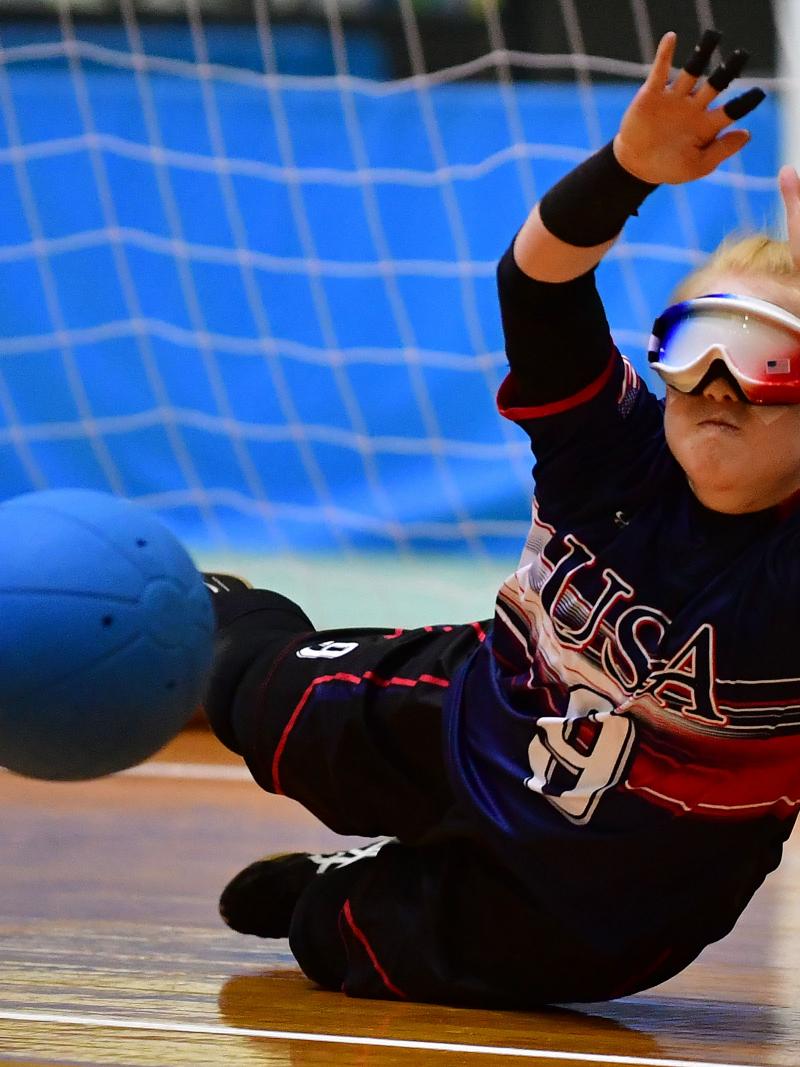 US goalball player Marybai Huking throws herself to the floor to prevent a ball from flying into the net