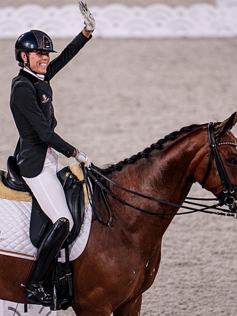 Michele George smiles and waves on her horse Best of 8