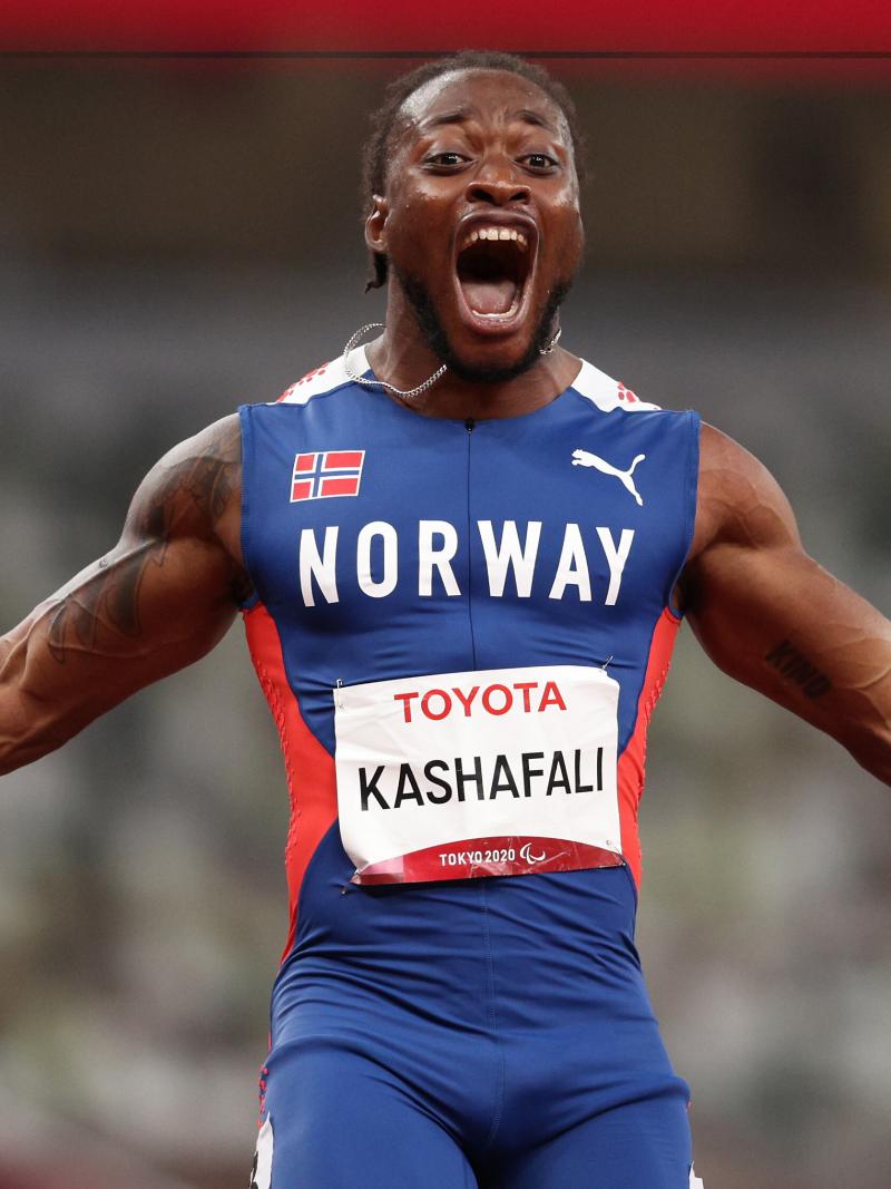 A man celebrates the victory with open arms and a big smile
