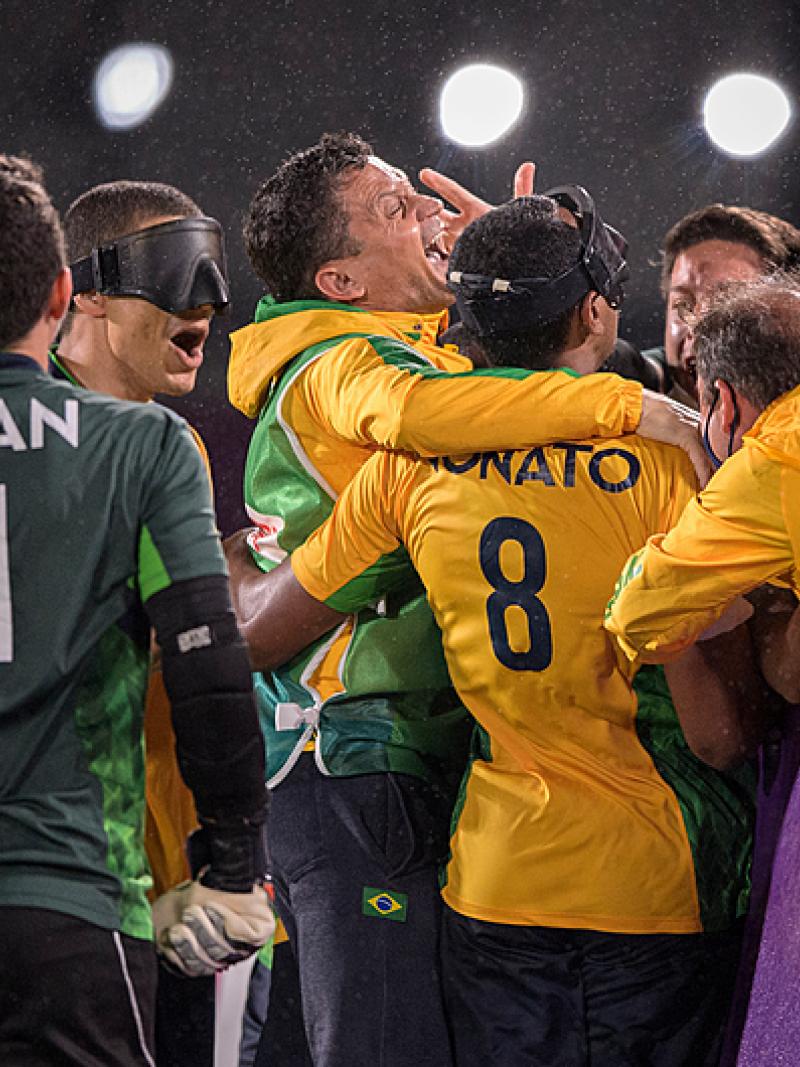 Scorer Nonato is mobbed by team-mates after his goal clinched gold