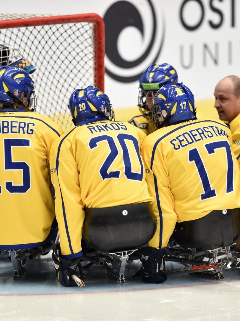 Para ice hockey players making a circle around the goalkeeper before the game
