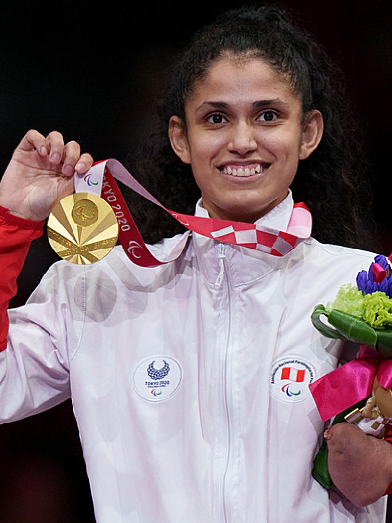 Peruvian taekwondin Angelica Espinoza smiles on the podium while holding the gold medal