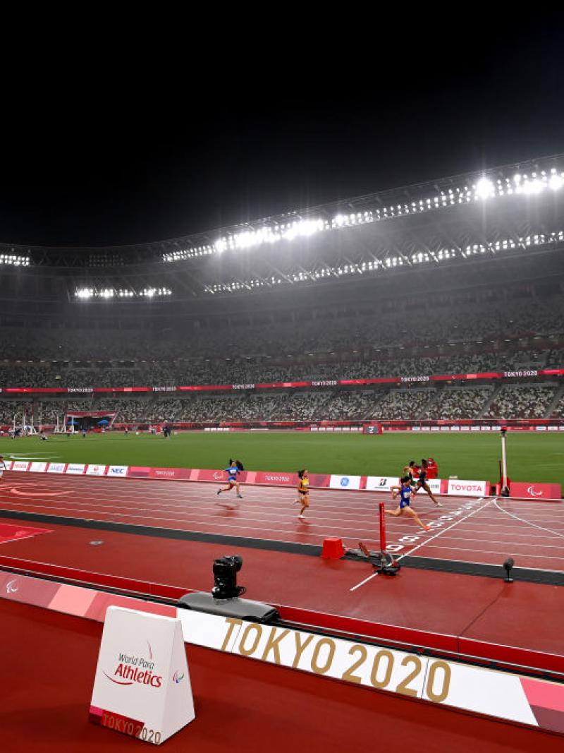 An athletics stadium during a rainy evening 