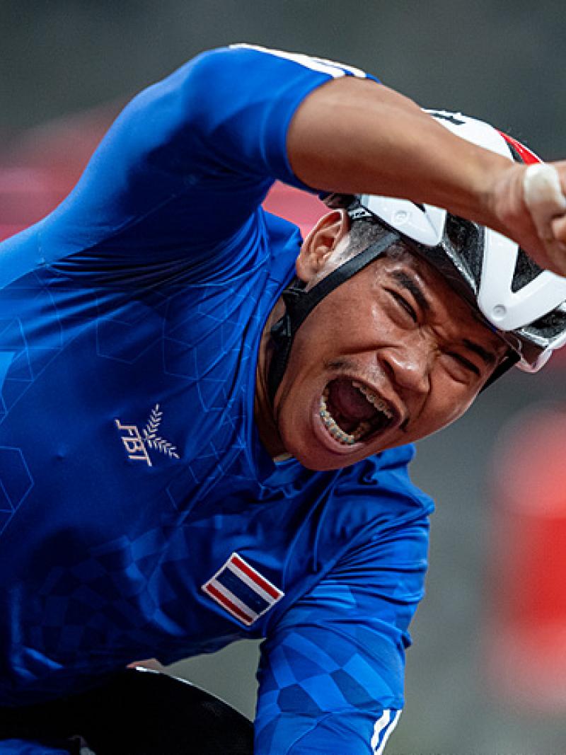 Thai wheelchair racer Pongsakorn Paeyo celebrates after crossing the finish line