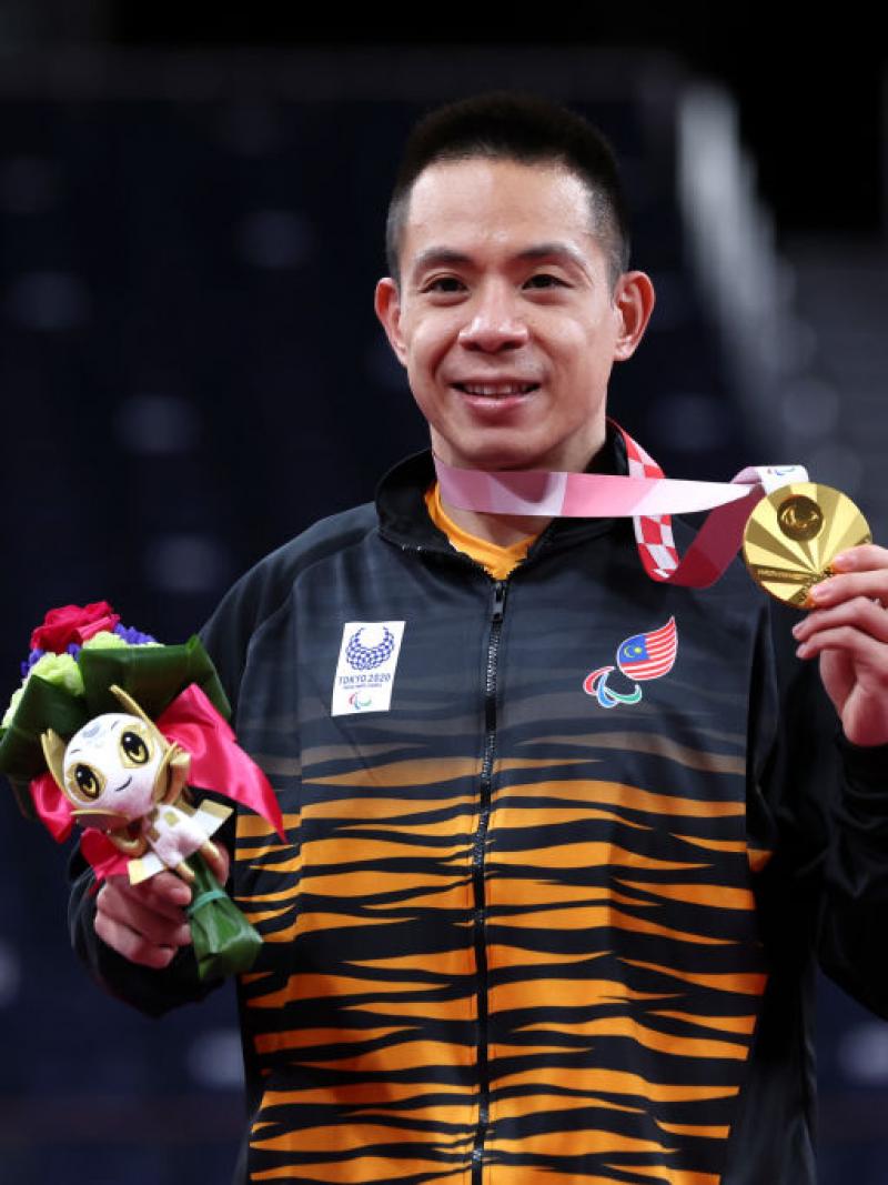 Malaysian man smiles with gold medal
