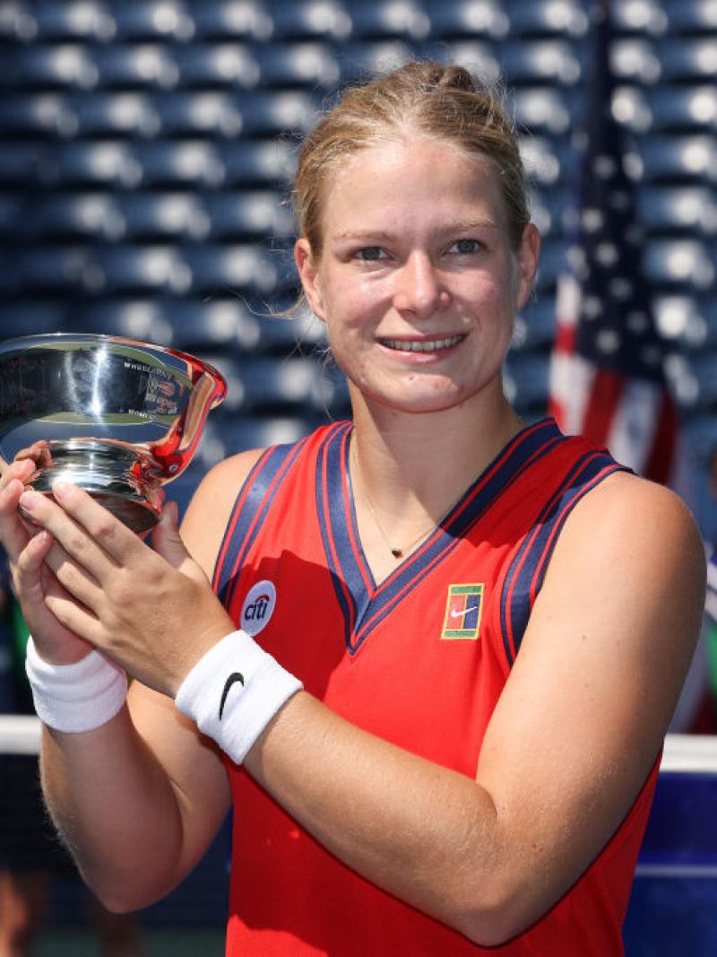 Woman holds up US Open trophy