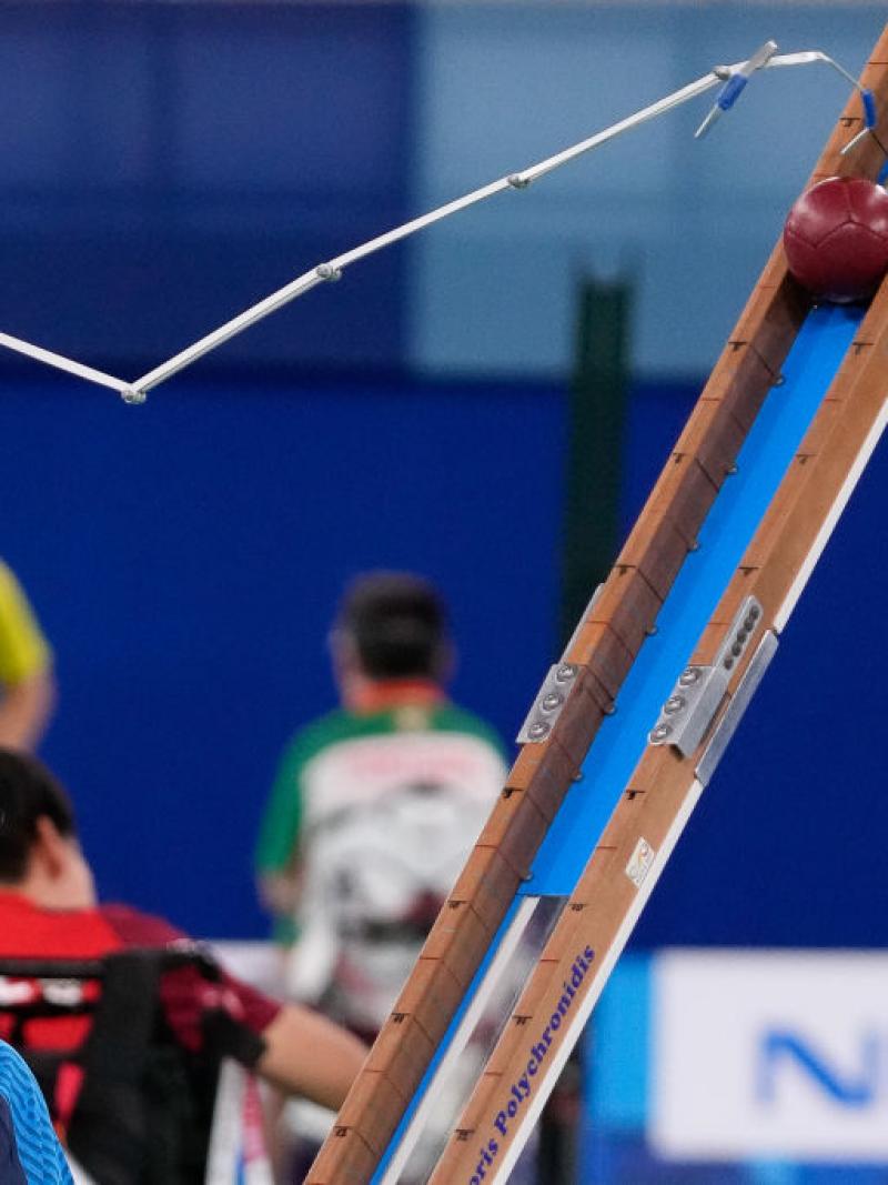 Boccia male athlete uses pointer to push ball