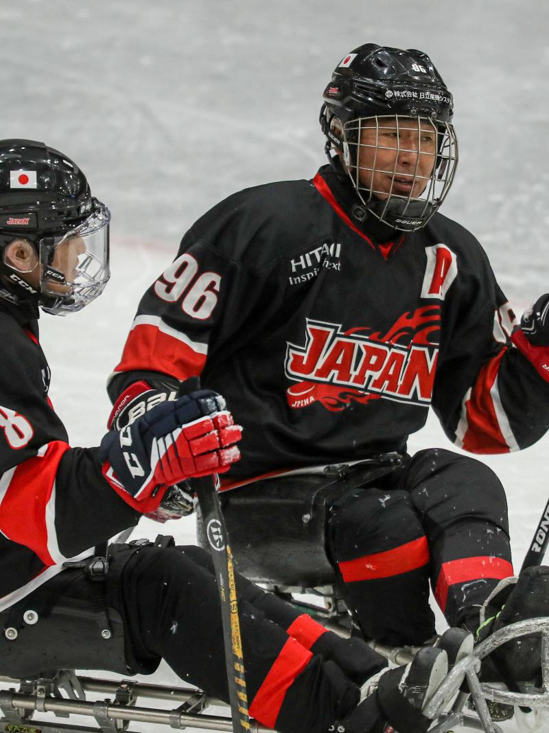 Two players on sledges looking in front of them