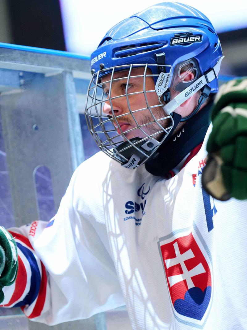 A Para ice hockey player gazing on the bench
