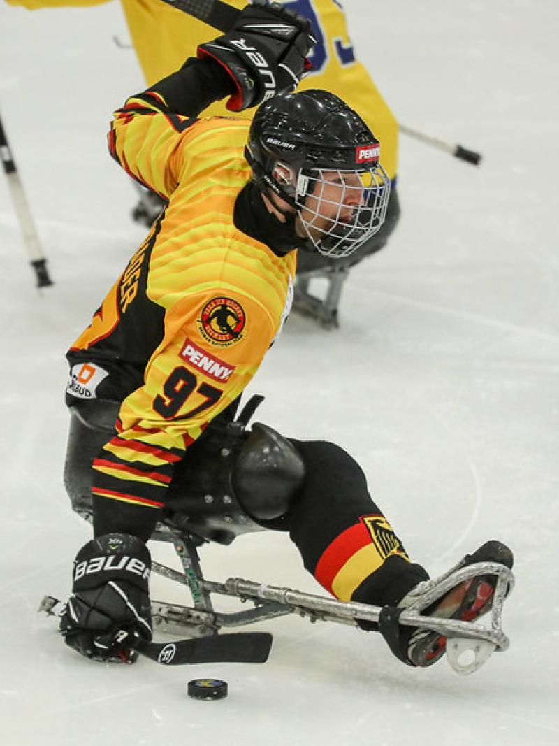 A Para ice hockey player with the Germany uniform on an ice rink