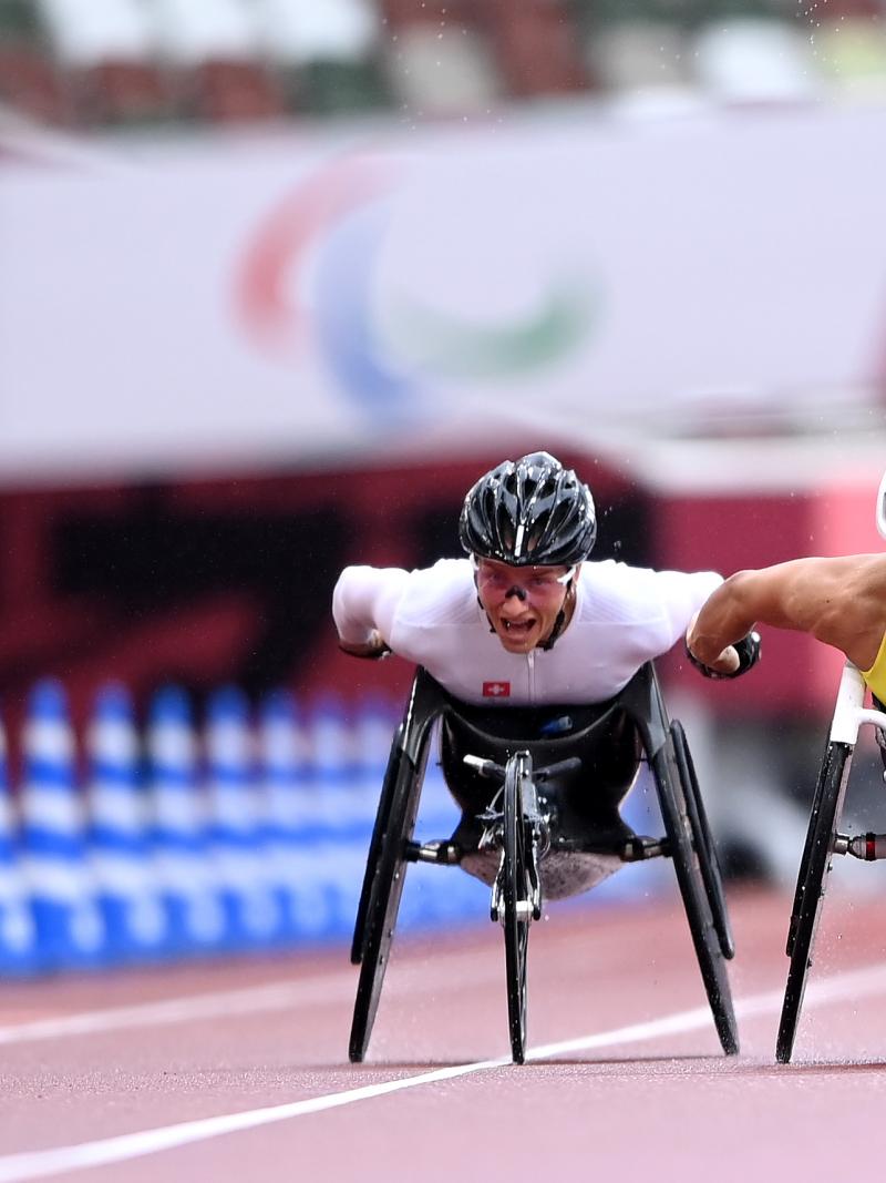 Two wheelchair racers getting close to the finish line