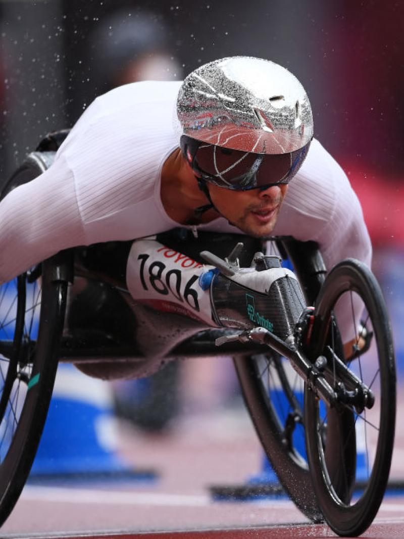 A male wheelchair racer competing in an athletics track